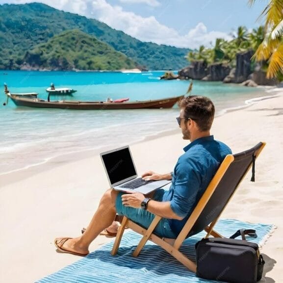 A digital nomad enjoying the Bali lifestyle, working on a laptop on a sunny beach with a serene ocean view—an ideal setting for Bali for Digital Nomads.